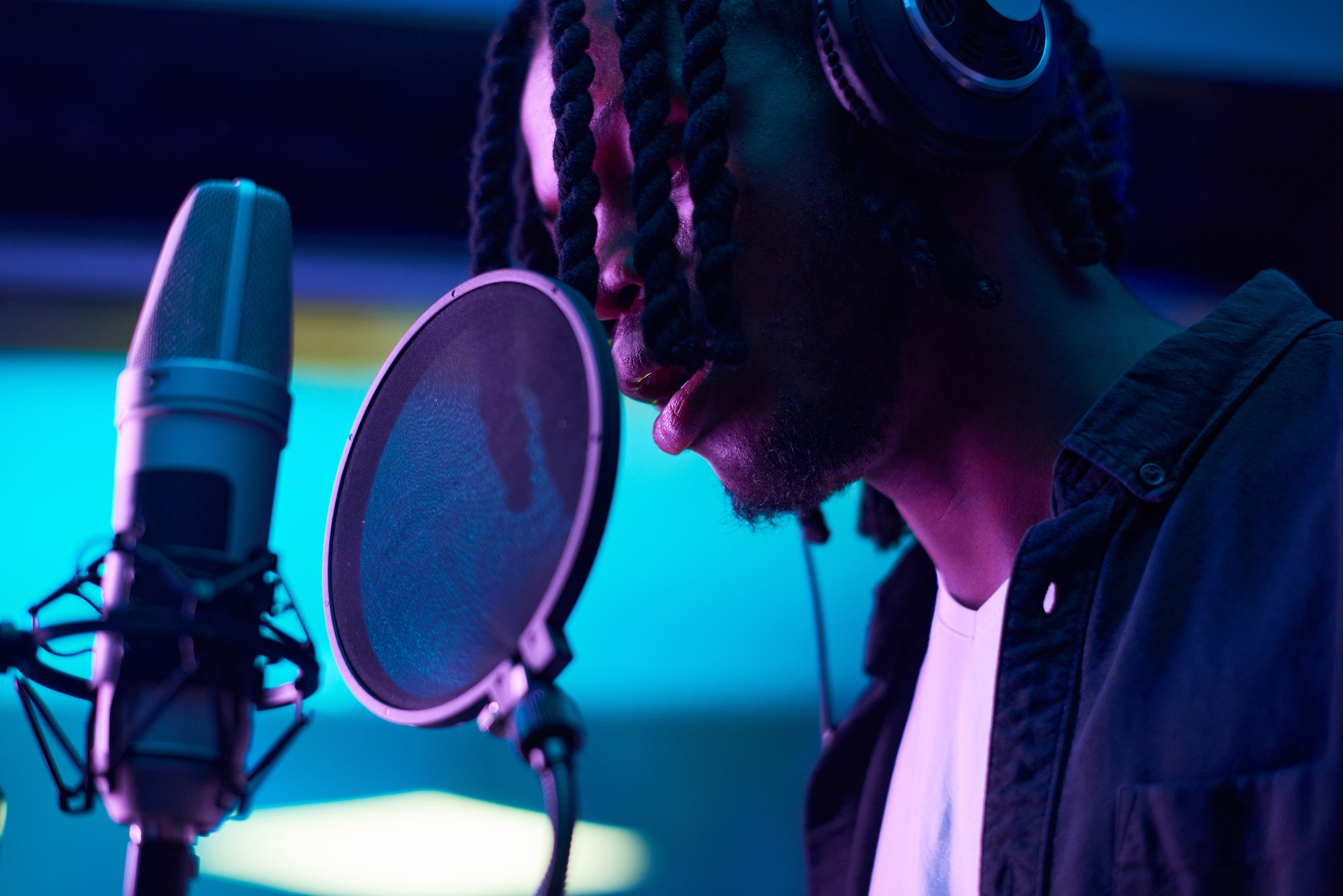 Man singing to microphone in music studio